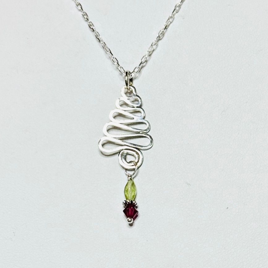 Close up of a Holiday Swirl Tree Necklace